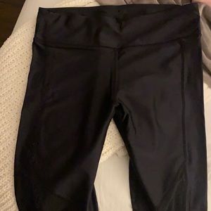 Black Fabletics shiny Marietta leggings with mesh cutouts near knee
